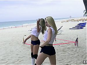 three nubile cuties catch a yam-sized impaler on the beach